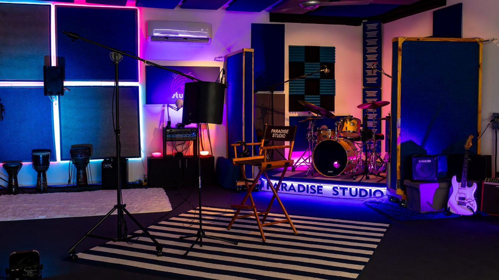 Paradise Studio Blue Room — live room with drum riser and blue lighting / Sala azul — sala en vivo con tarima de batería e iluminación azul